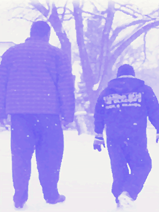 Photo of 2 people walking in the snow